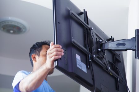Installing mount TV on the wall at home or office